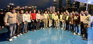 WWTFE delegation on a rooftop in Singapore at night